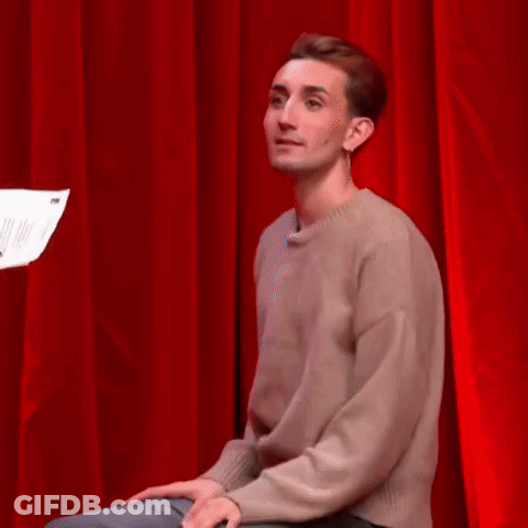 Woman Standing In Front Of Red Curtain With Paper GIF