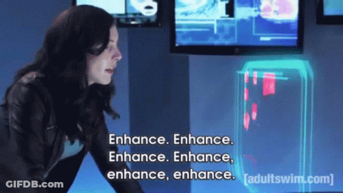 A Woman Is Standing In Front Of A Screen That Says Enhance Enhance Enhance Enhance Enhance Enhance GIF