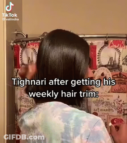 A Woman Is Standing In Front Of A Shower Curtain While Getting Her Hair Trimmed . GIF