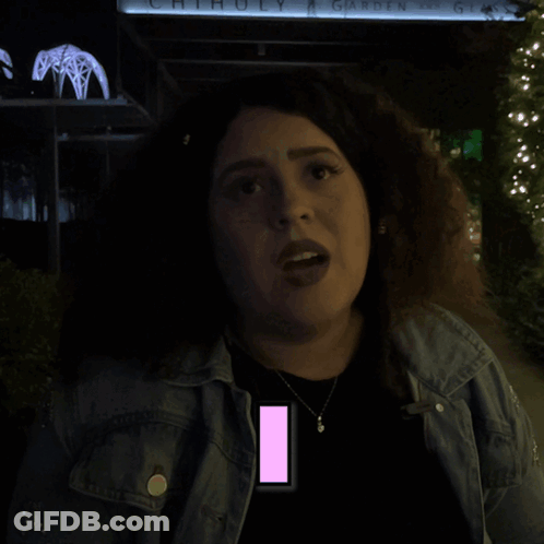 A Woman Is Standing In Front Of A Sign That Says Chihuly Garden Glass GIF