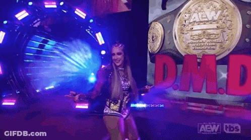 A Woman Is Standing In Front Of A Sign That Says Dm.d. GIF