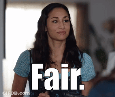 A Woman Is Standing In Front Of A Sign That Says " Fair " GIF