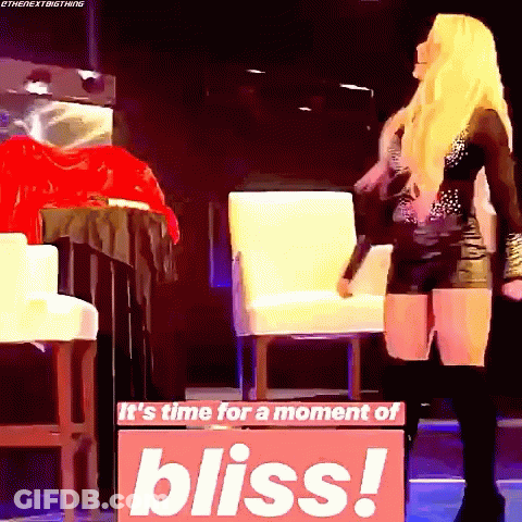 A Woman Is Standing In Front Of A Sign That Says It 'S Time For A Moment Of Bliss GIF