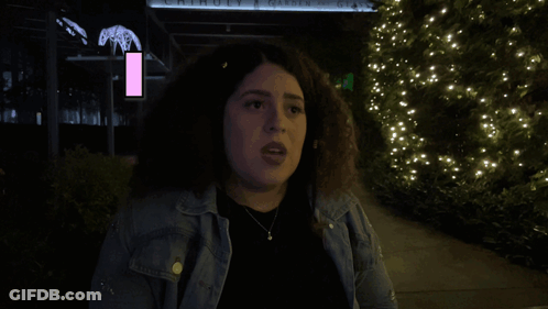 A Woman Is Standing In Front Of A Sign That Says Move On It GIF
