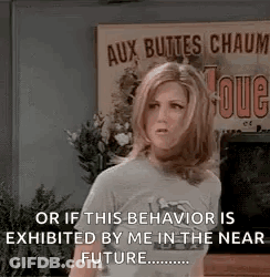 A Woman Is Standing In Front Of A Sign That Says `` Or If This Behavior Is Exhibited By Me In The Near Future ... '' GIF