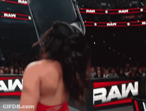 A Woman Is Standing In Front Of A Sign That Says Raw GIF