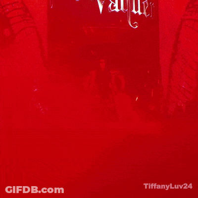A Woman Is Standing In Front Of A Sign That Says Stephanie Varquez GIF