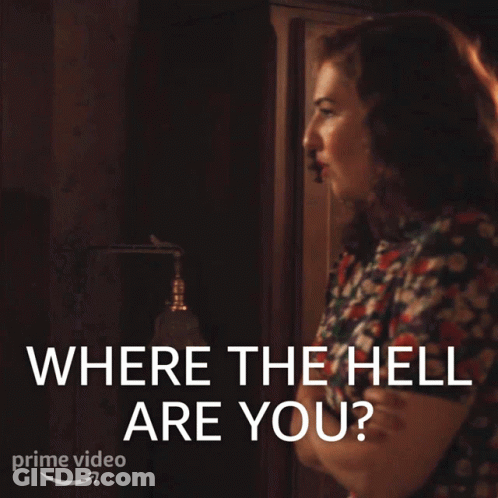 A Woman Is Standing In Front Of A Sign That Says Where The Hell Are You GIF