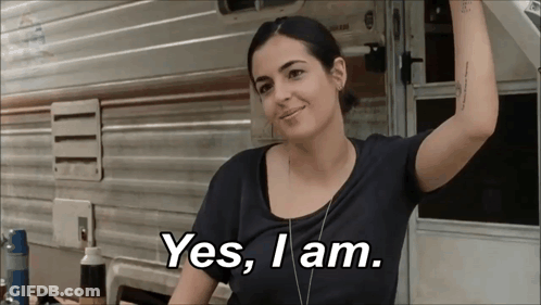 A Woman Is Standing In Front Of A Trailer And Says Yes I Am GIF