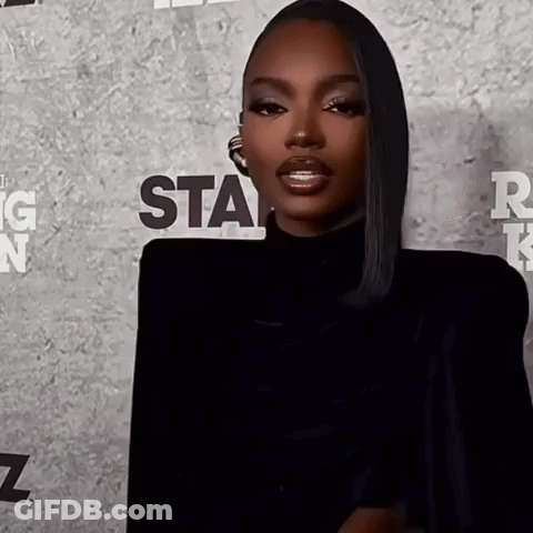 A Woman Is Standing In Front Of A Wall That Says Star GIF