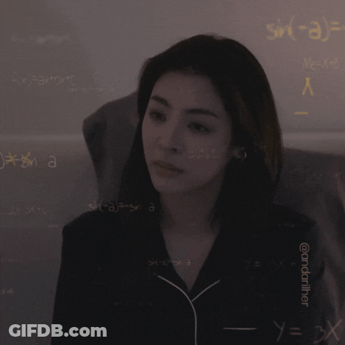 A Woman Is Standing In Front Of A Wall With Mathematical Equations On It GIF