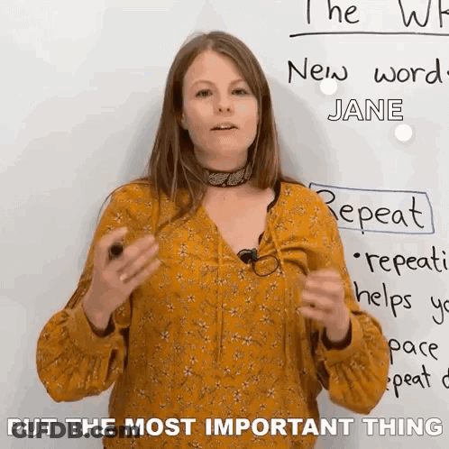 A Woman Is Standing In Front Of A White Board With The Words Put The Most Important Thing On It . GIF