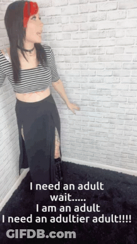 A Woman Is Standing In Front Of A White Brick Wall And Says I Need An Adult GIF