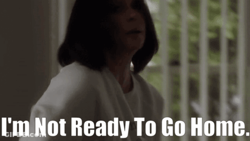 A Woman Is Standing In Front Of A Window And Says I 'M Not Ready To Go Home GIF