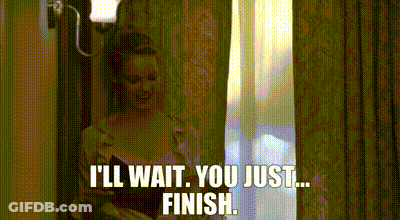 A Woman Is Standing In Front Of A Window And Talking To Someone . GIF