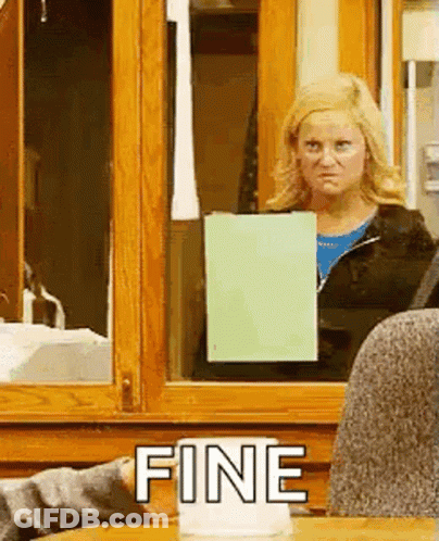 A Woman Is Standing In Front Of A Window Holding A Piece Of Paper And The Word Fine Is On The Table . GIF