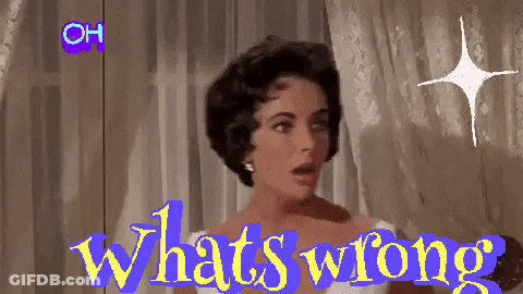 A Woman Is Standing In Front Of A Window With The Words " What 'S Wrong " On The Screen GIF