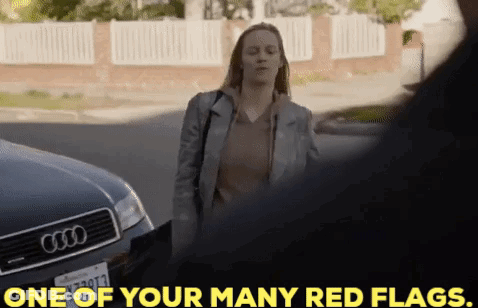A Woman Is Standing In Front Of An Audi Car And Talking To A Man . GIF