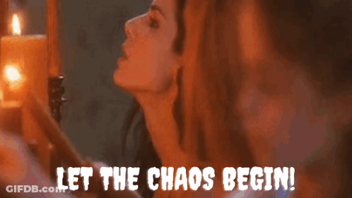 A Woman Is Standing In Front Of Candles With The Words Let The Chaos Begin GIF