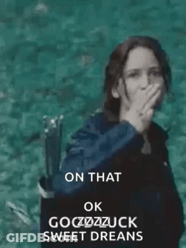 A Woman Is Standing In The Water With Her Hand Up In The Air . GIF