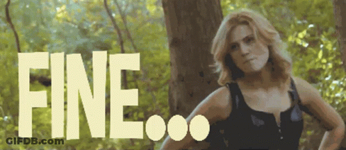 A Woman Is Standing In The Woods And The Word Fine Is Visible Behind Her GIF