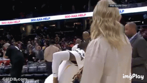 A Woman Is Standing Next To A Basketball Player In A Fox Sports Ohio Stadium GIF