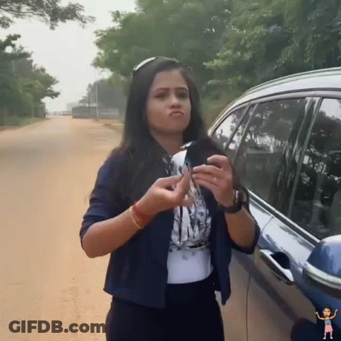 A Woman Is Standing Next To A Car Holding A Key GIF