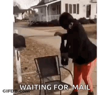 A Woman Is Standing Next To A Chair In Front Of A Mailbox And Waiting For Mail . GIF