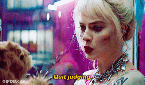 A Woman Is Standing Next To A Dog And Talking To It While Wearing A Necklace . GIF