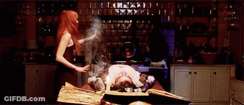 A Woman Is Standing Next To A Man Laying On A Table With A Book Open On It . GIF