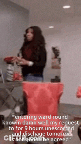 Woman Standing Next To Red Trash Can GIF
