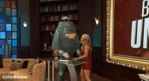 A Woman Is Standing Next To A Robot That Says Ziggy 1988 GIF