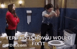 A Woman Is Standing Next To A Toilet With A Hammer In Her Hand . GIF