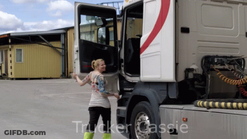 A Woman Is Standing Next To A Truck With The Word Trucker Cassie On The Bottom GIF