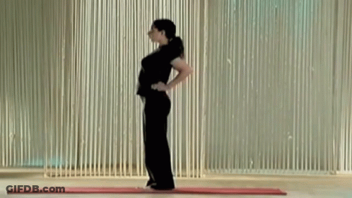 A Woman Is Standing On A Mat With Her Hands On Her Hips . GIF