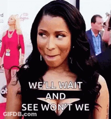 A Woman Is Standing On A Red Carpet And Making A Face . GIF