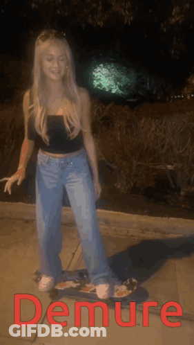 A Woman Is Standing On A Skateboard With The Word Demure In Red Letters GIF