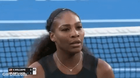 A Woman Is Standing On A Tennis Court With A Scoreboard Behind Her . GIF