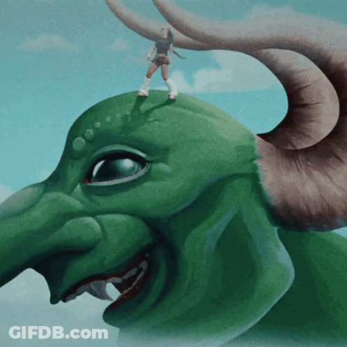 A Woman Is Standing On Top Of A Green Monster GIF