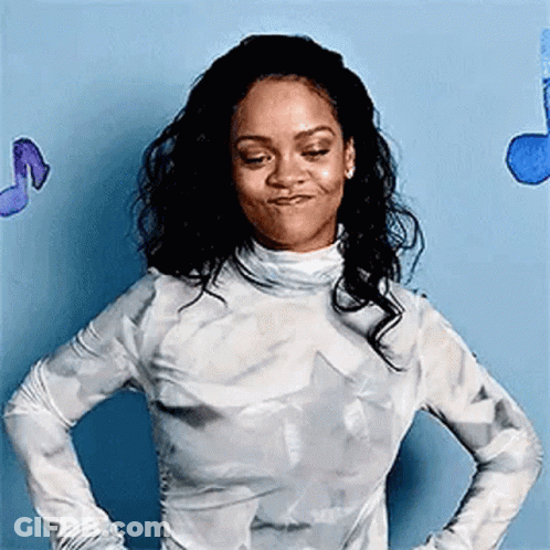 A Woman Is Standing With Her Hands On Her Hips In Front Of A Blue Wall With Music Notes . GIF