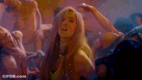 A Woman Is Surrounded By A Group Of Men In A Dark Room GIF
