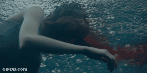 A Woman Is Swimming In A Pool With Her Head Down GIF