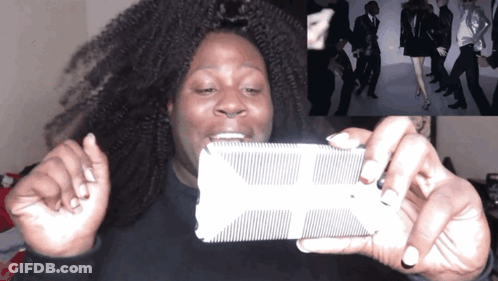 A Woman Is Taking A Picture Of A Group Of People GIF
