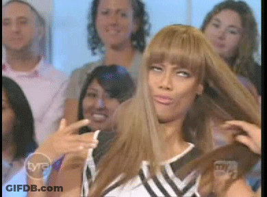 A Woman Is Taking A Picture Of Herself In Front Of A Tv Screen That Says Tnt GIF