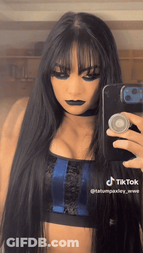 A Woman Is Taking A Picture Of Herself With A Tiktok Watermark GIF