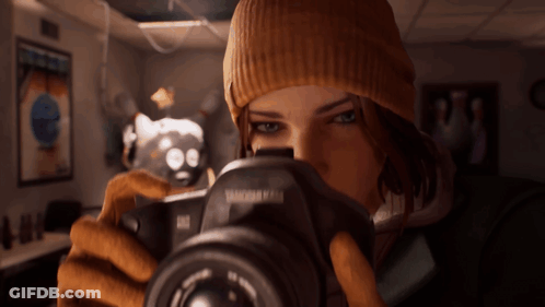 A Woman Is Taking A Picture With A Camera That Says Tamron On It GIF