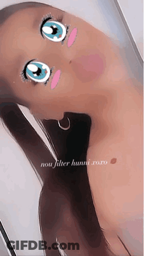 A Woman Is Taking A Selfie With A Cartoon Face On Her Face And The Caption Says Non Filter Hunni Xoxo GIF