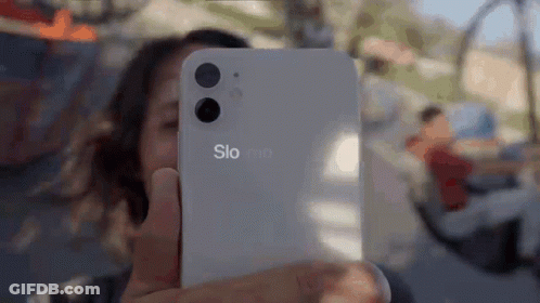 A Woman Is Taking A Selfie With A Phone That Says Slo Mo GIF