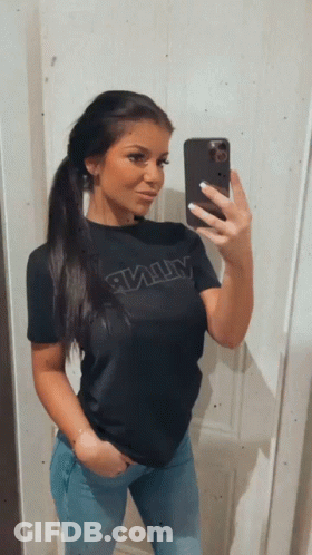 A Woman Is Taking A Selfie With Her Phone While Wearing A Black Shirt With The Word Army On It GIF
