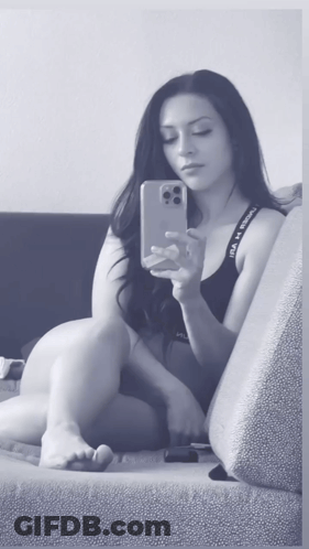 A Woman Is Taking A Selfie With Her Phone While Wearing Under Armour Underwear GIF